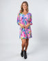 Woman wearing a colorful dress on a white background