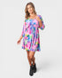 Woman wearing a colorful floral dress on a white background