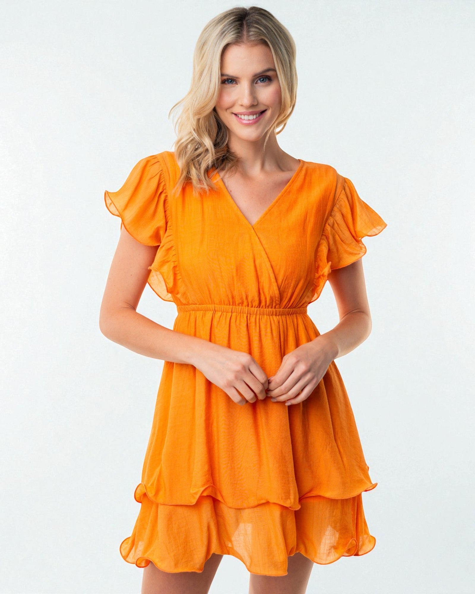 Woman wearing an orange dress on a white background