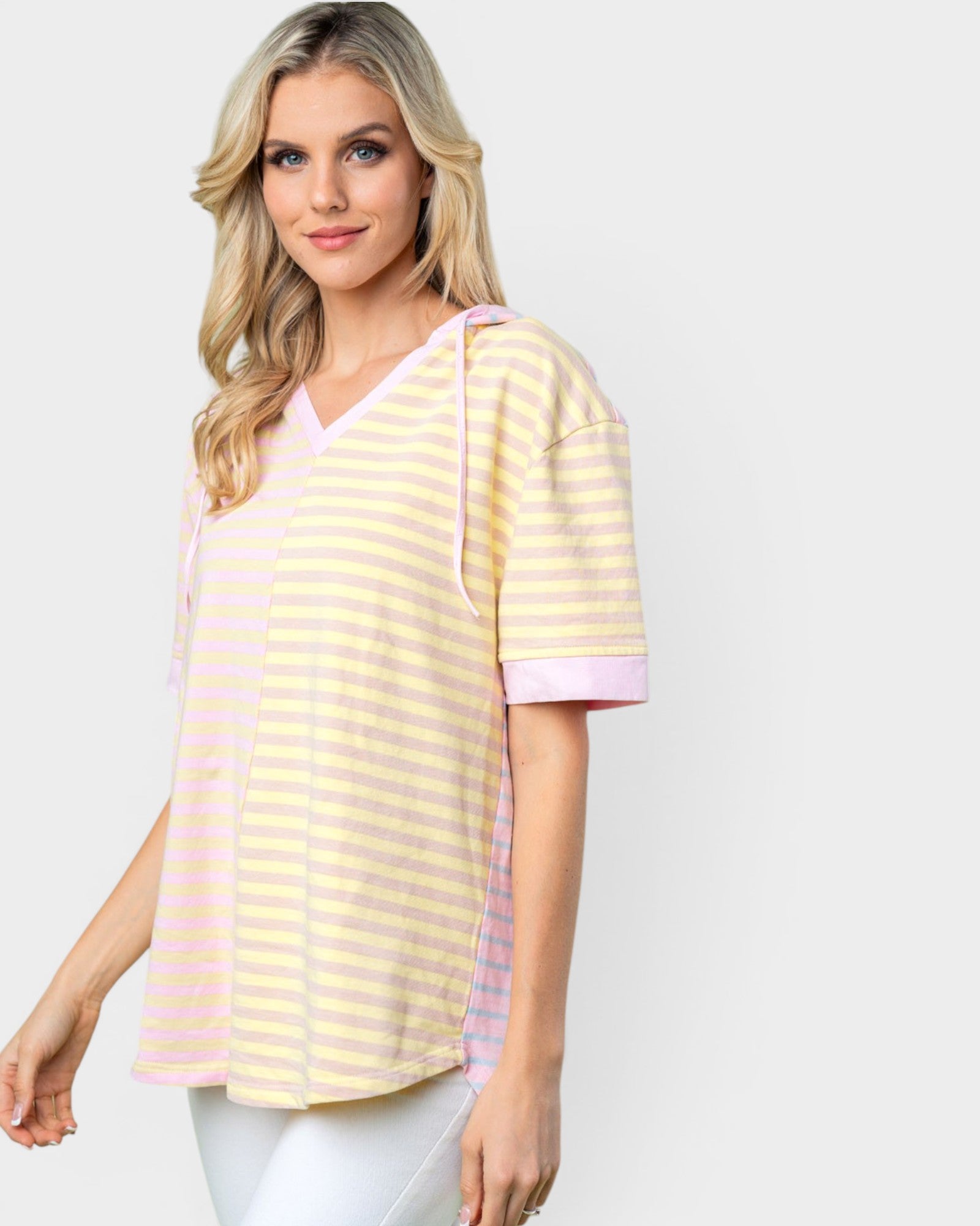 Woman wearing a yellow and pink striped shirt on a white background