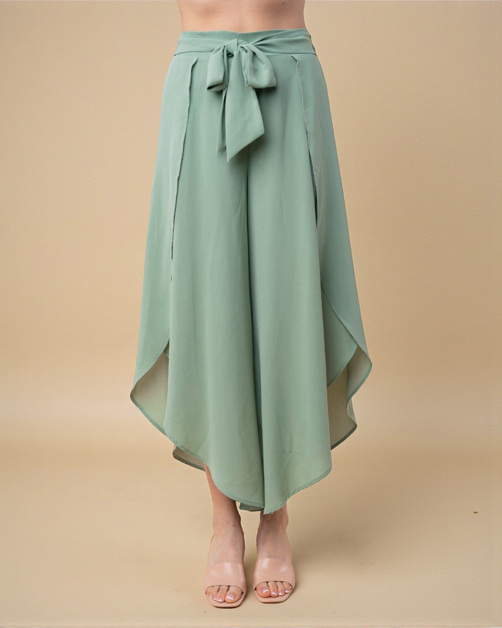 Green skirt with a tie waist on a beige background