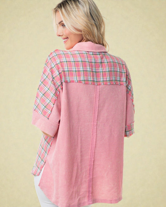 Woman wearing a pink plaid shirt against a beige background