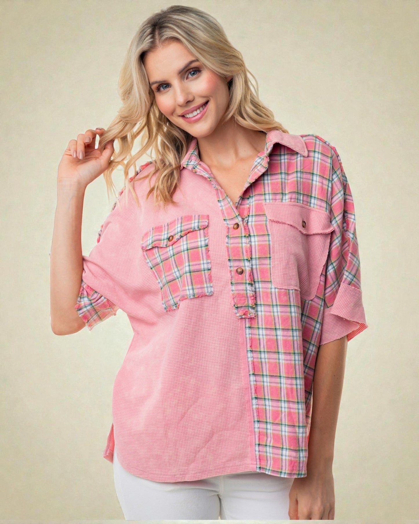 Woman wearing a pink plaid shirt against a beige background
