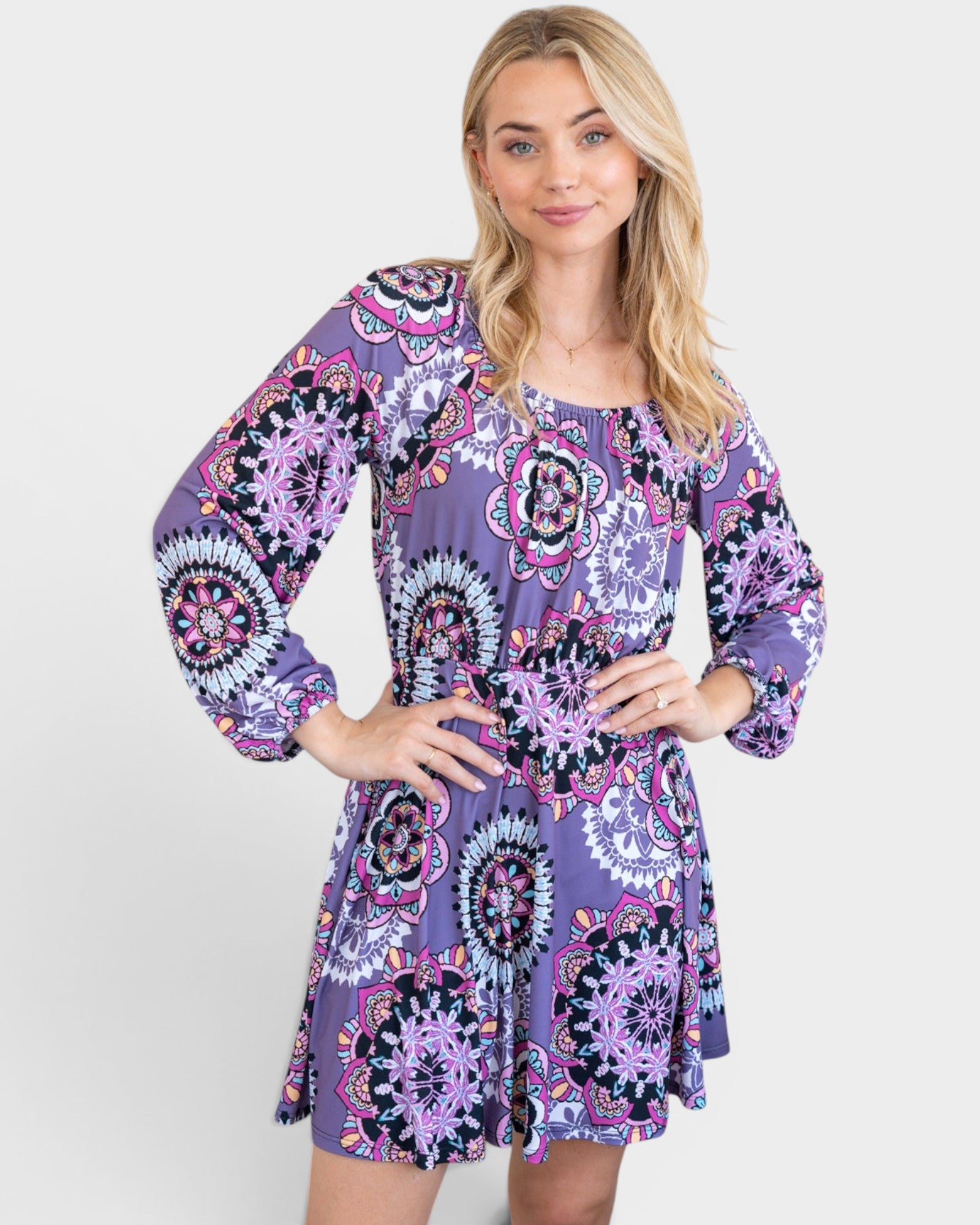 Woman wearing a purple patterned dress on a white background