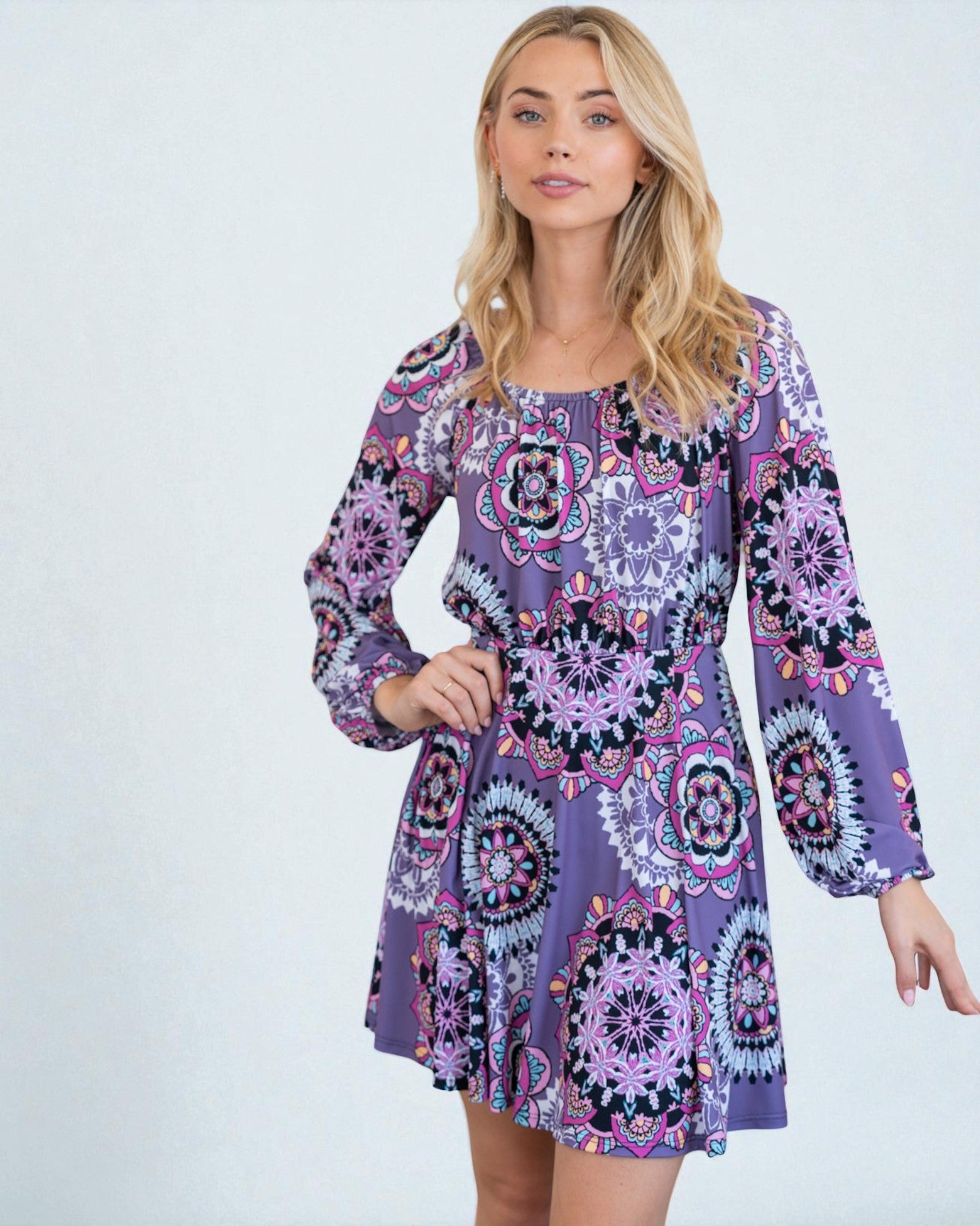 Woman wearing a purple patterned dress on a white background