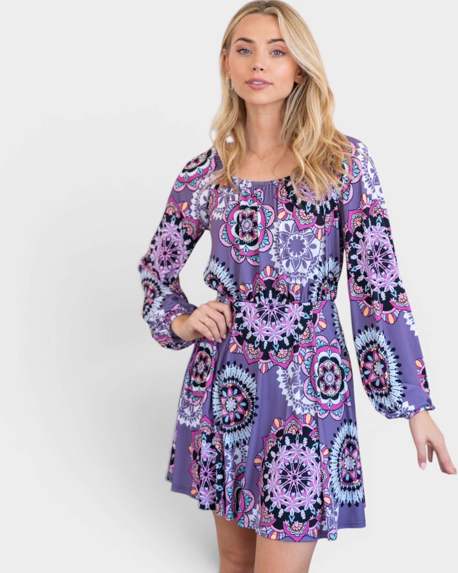 Woman wearing a purple patterned dress on a white background