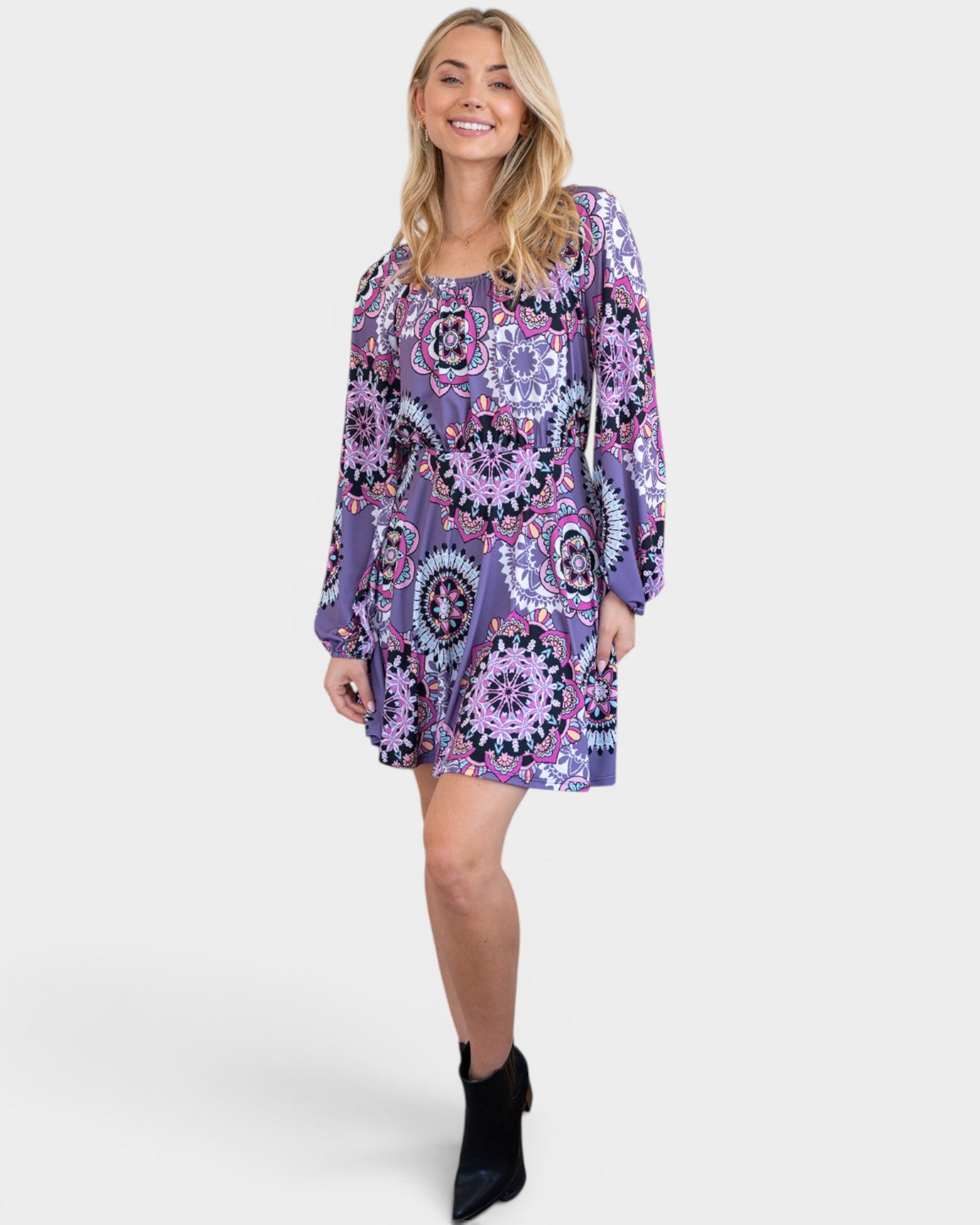 Woman wearing a purple patterned dress on a white background