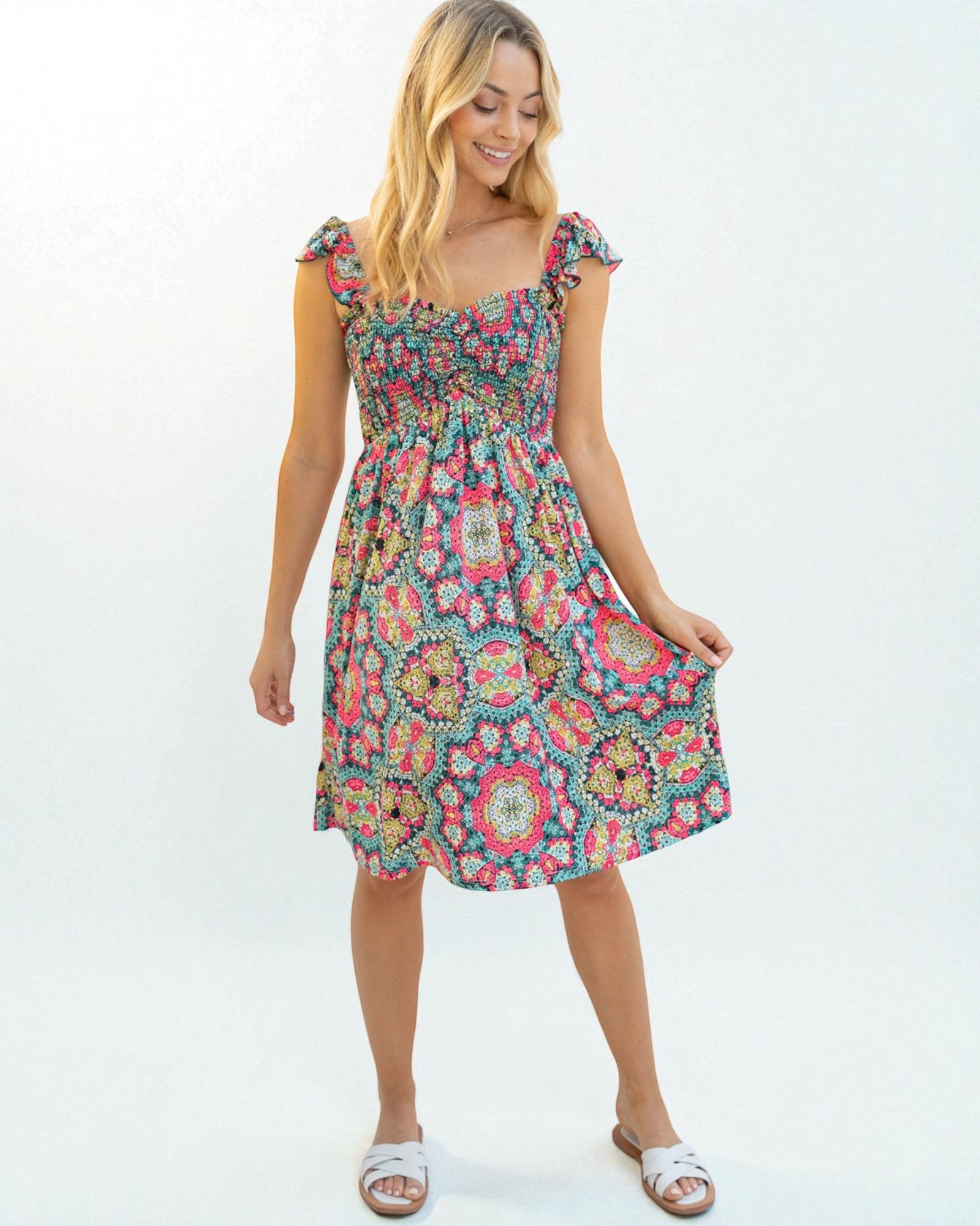 Woman wearing a colorful floral dress on a white background