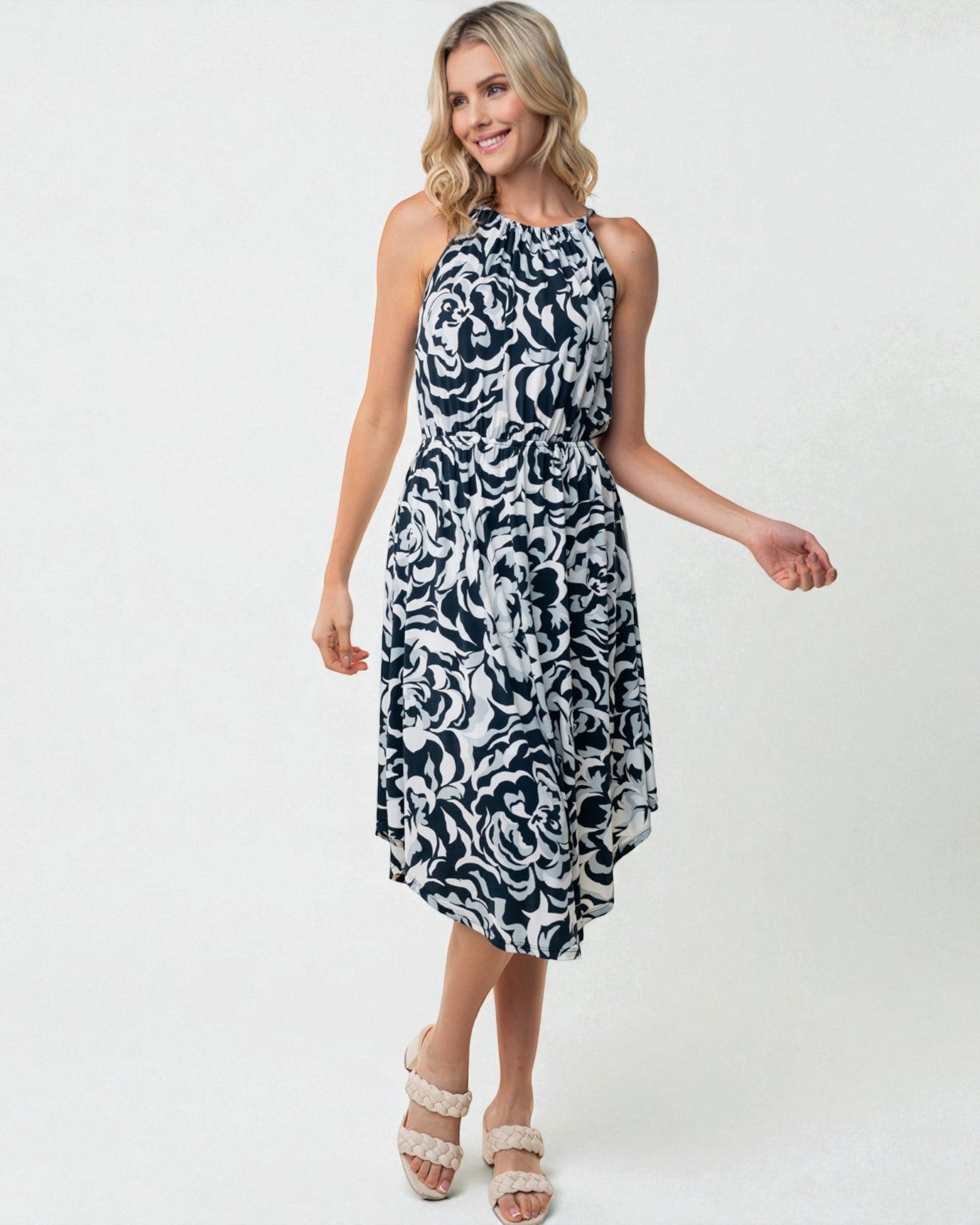 Woman wearing a black and white patterned dress on a white background