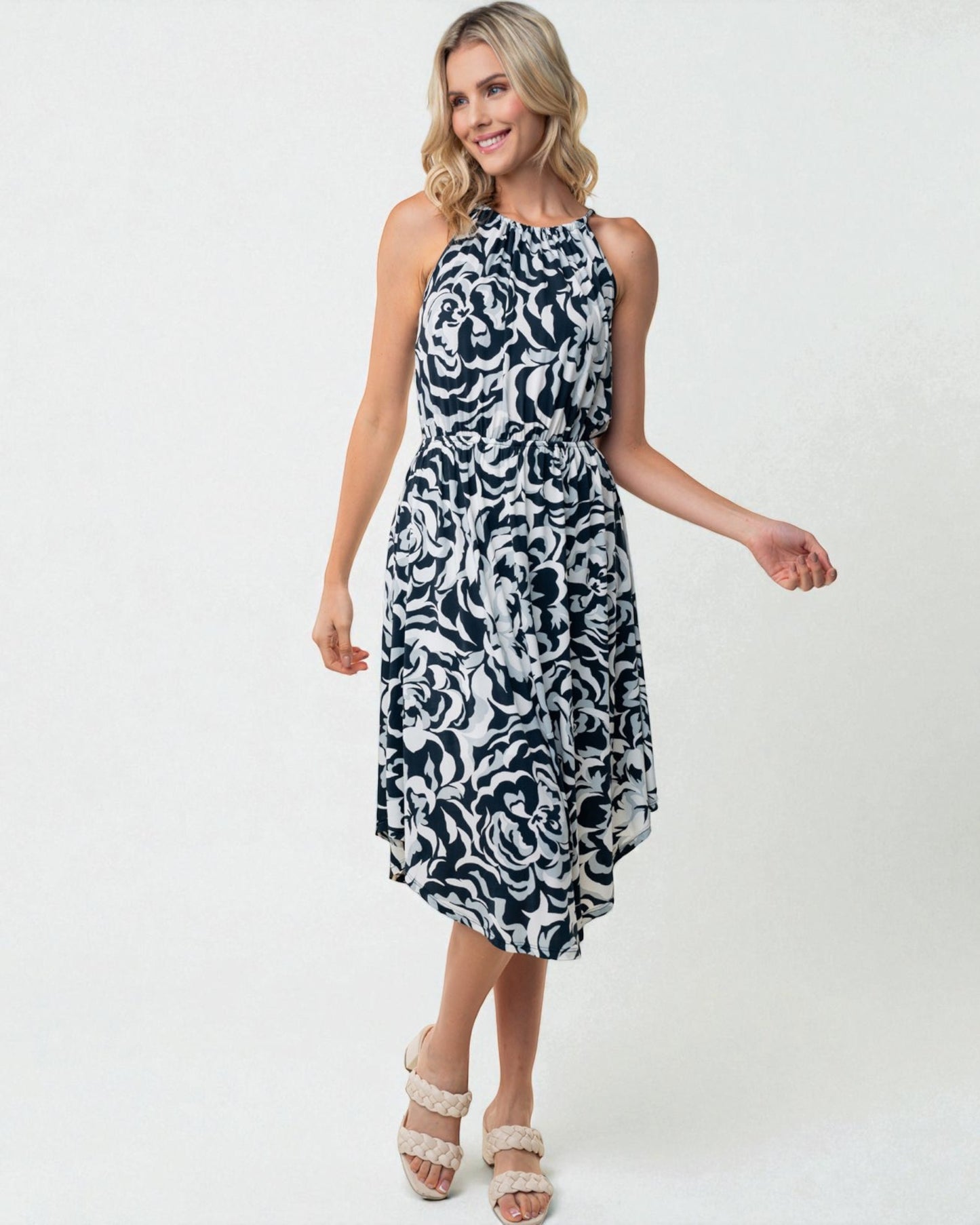 Woman wearing a black and white patterned dress on a white background