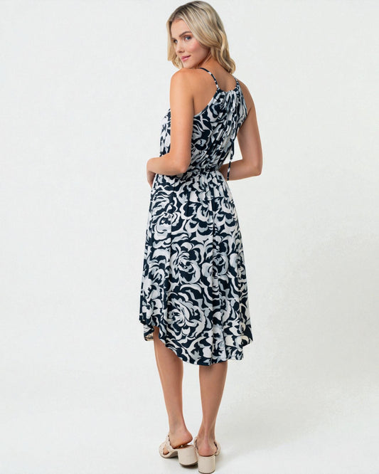 Woman wearing a black and white patterned dress on a white background