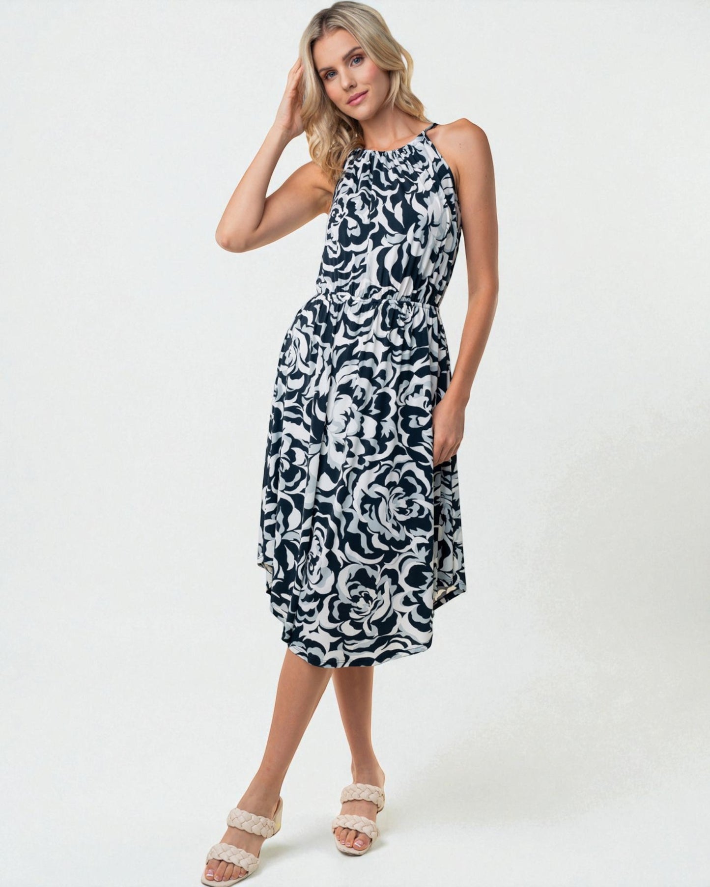 Woman wearing a black and white patterned dress on a white background