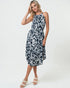 Woman wearing a black and white patterned dress on a white background