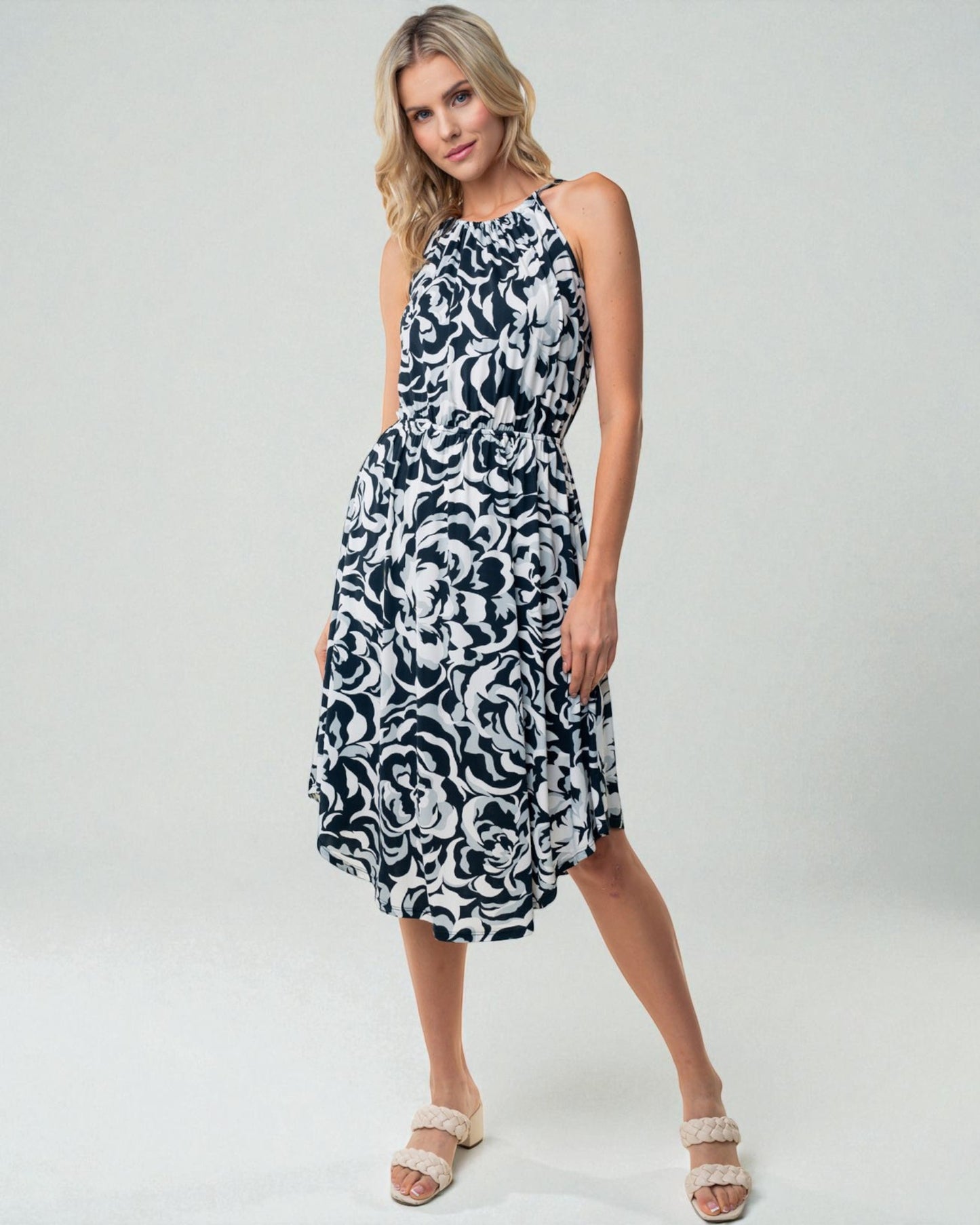 Woman wearing a black and white patterned dress on a white background