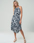 Woman wearing a black and white patterned dress on a white background