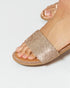 Gold glittery sandal on a white background