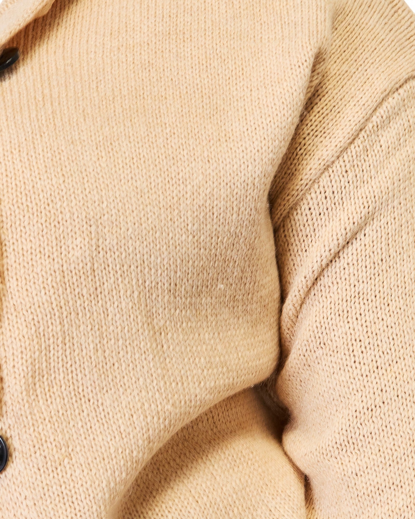 Close-up of beige fabric texture with a focus on the material and pattern.