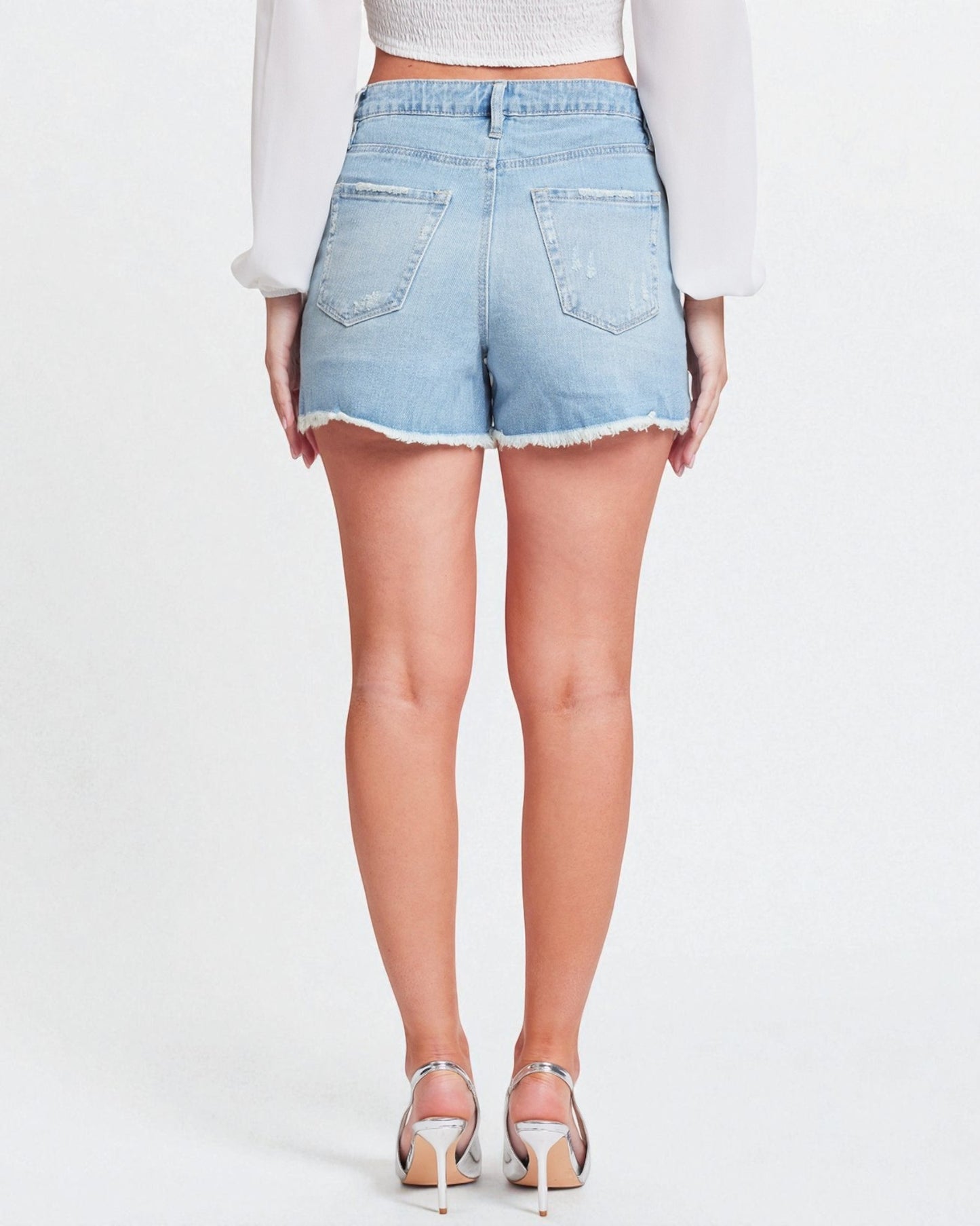 Light blue denim shorts worn by a person on a white background