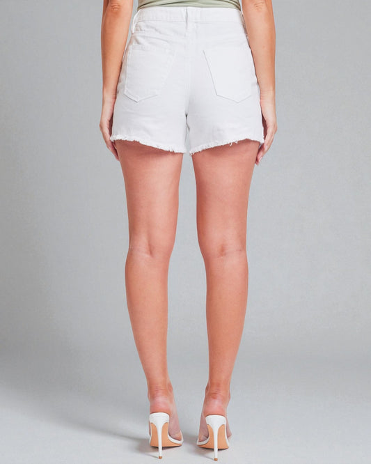 Person wearing white denim shorts on a plain background