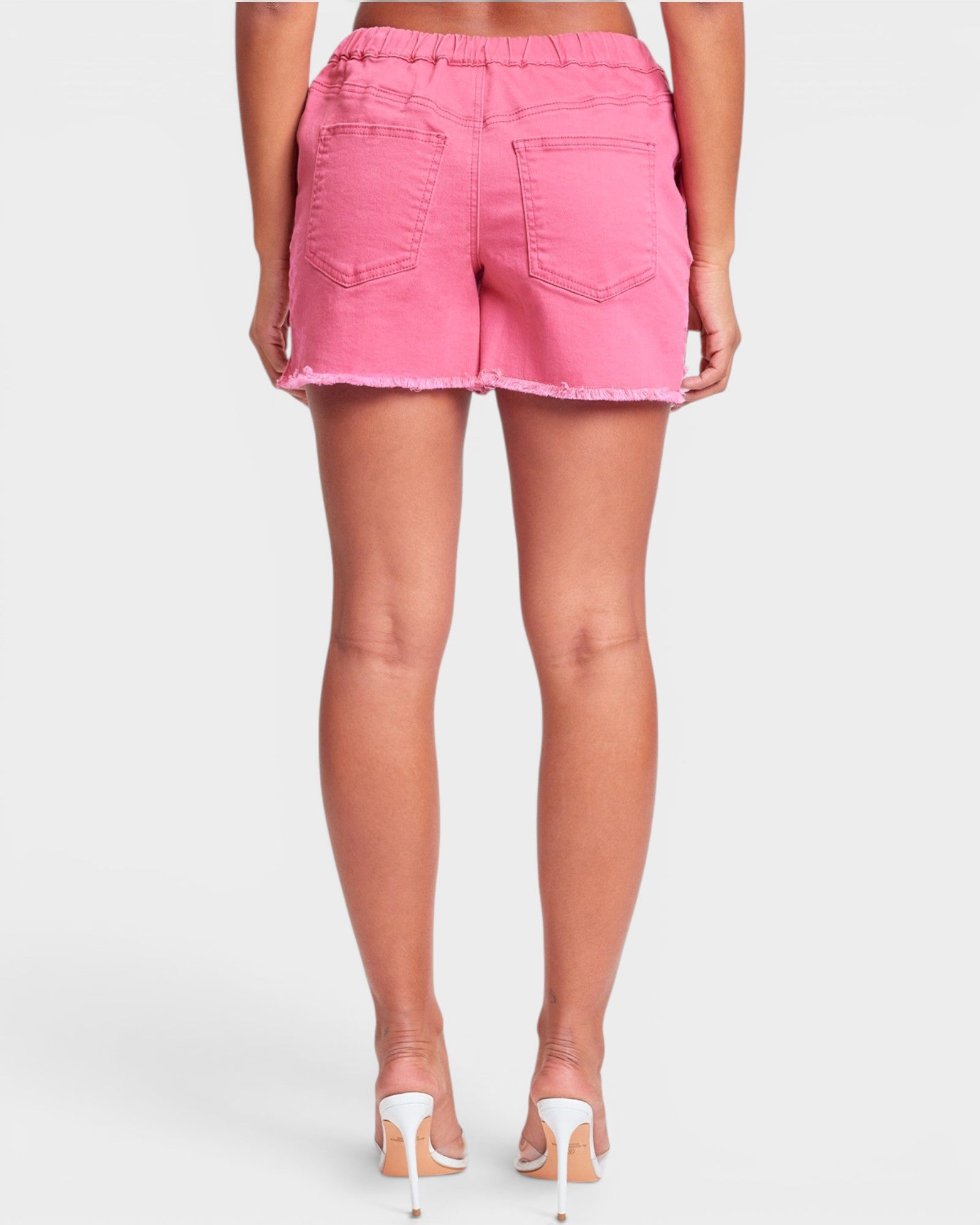 Person wearing pink shorts on a white background