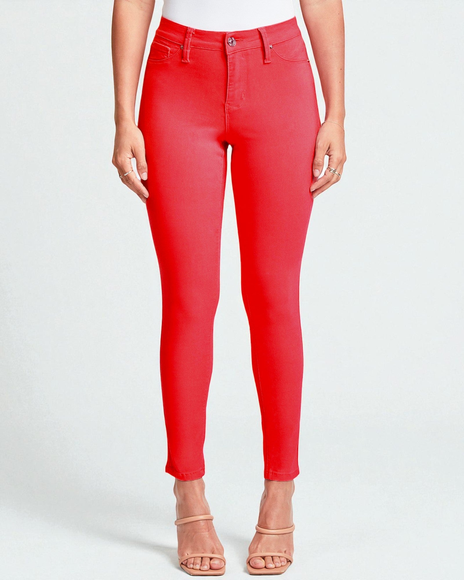 Red jeans worn by a person on a white background