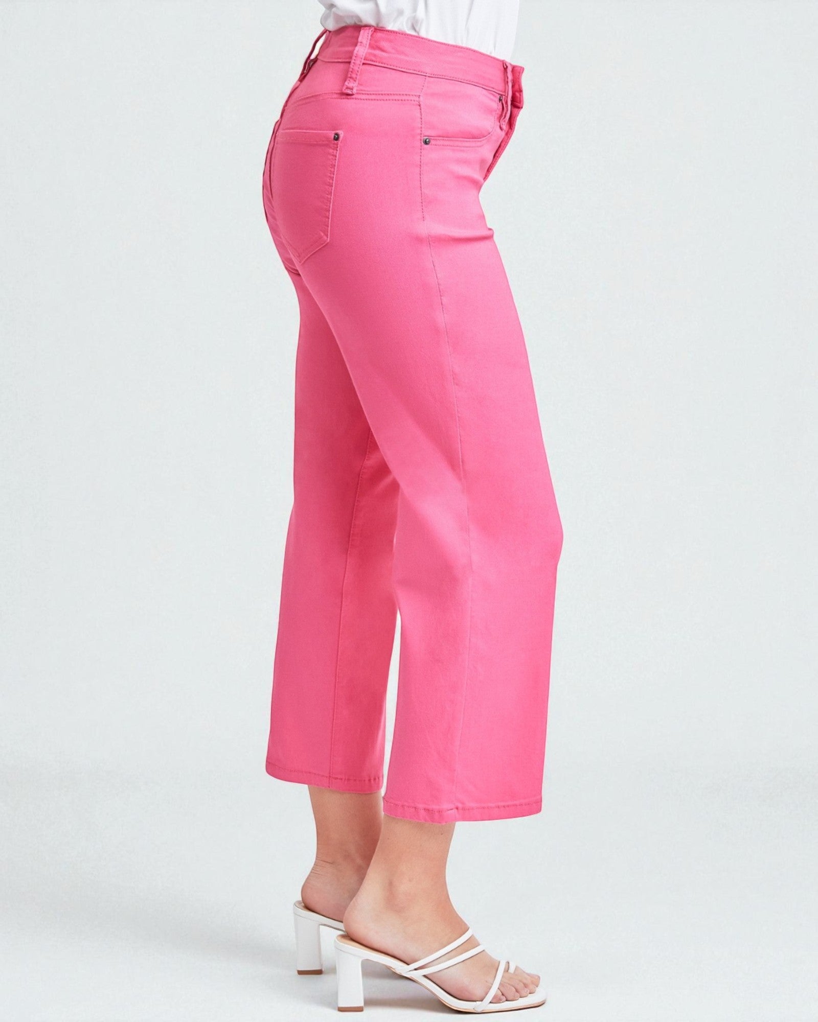 Pink pants worn by a person on a white background
