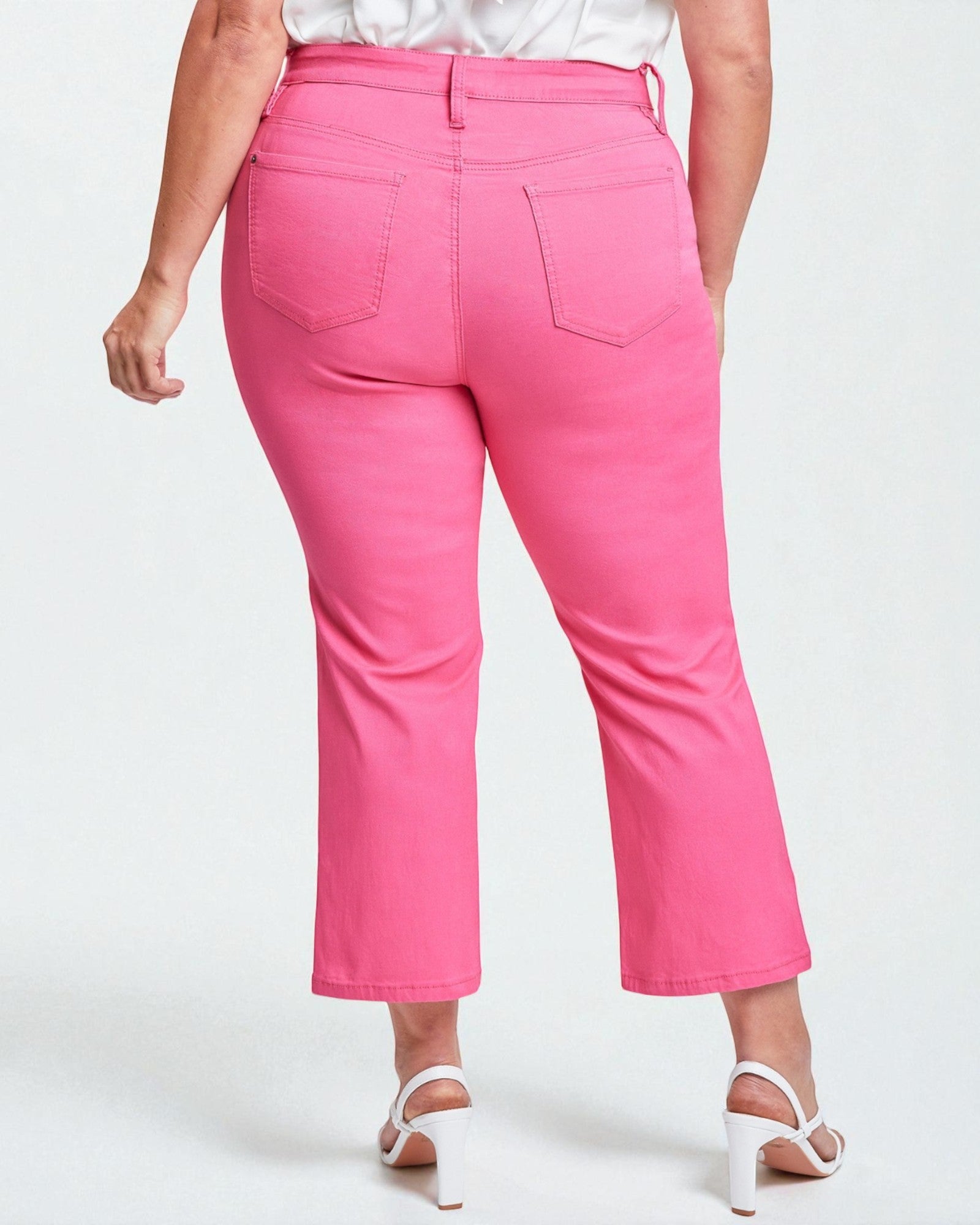 Person wearing bright pink pants on a white background