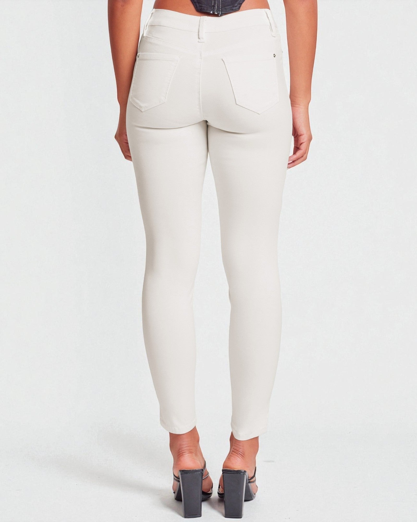 White pants worn by a person on a white background
