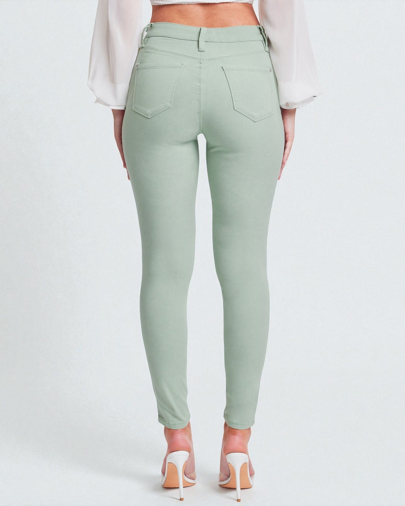 Mint green pants worn by a person on a white background