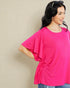 Woman wearing a bright pink top against a beige background