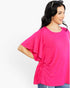 A woman wearing a bright pink short-sleeve top with flutter sleeves and a side tie detail, paired with blue jeans, photographed against a plain white background.