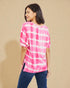 Woman wearing a pink and white striped shirt against a beige background