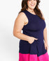 A plus-size woman wearing a sleeveless colorblock dress with a navy blue top and a bright pink bottom hem, shown against a plain white studio background.