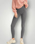 Person wearing gray leggings and a pink sweatshirt on a light gray background