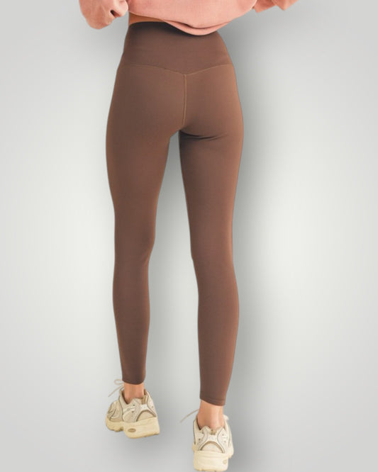 Brown leggings worn by a person on a light gray background