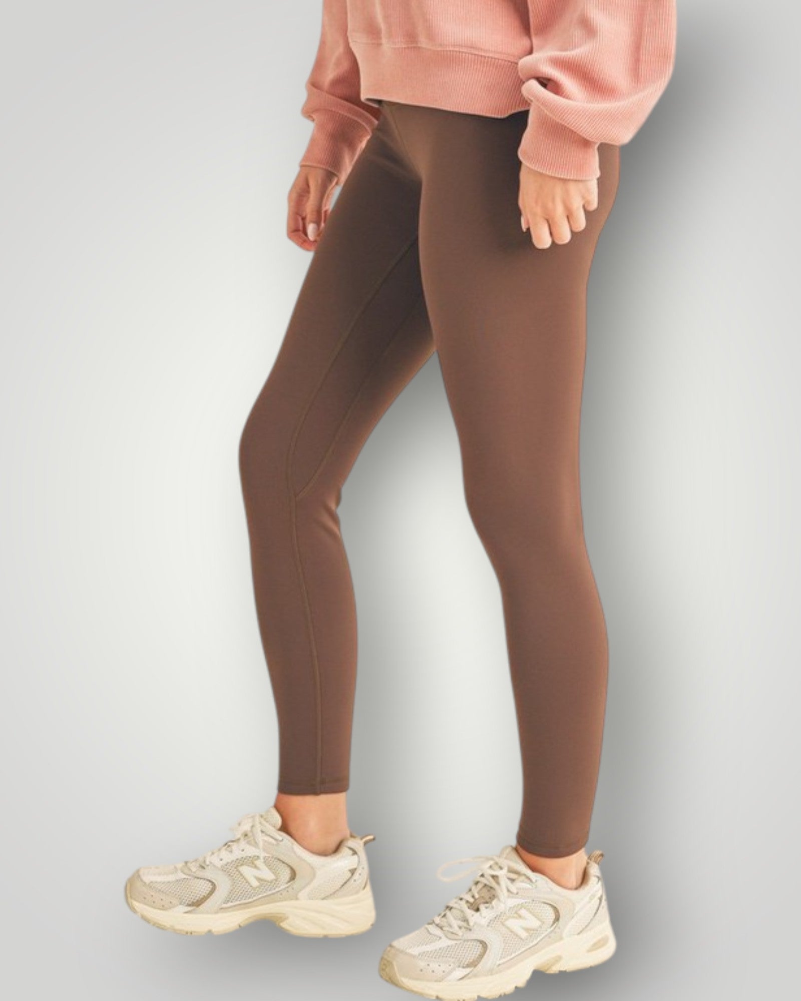 Brown leggings worn by a person on a light gray background