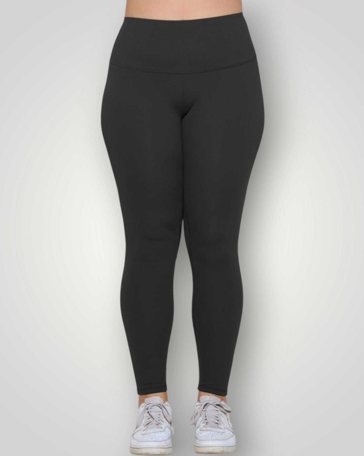 Black leggings worn by a person on a white background