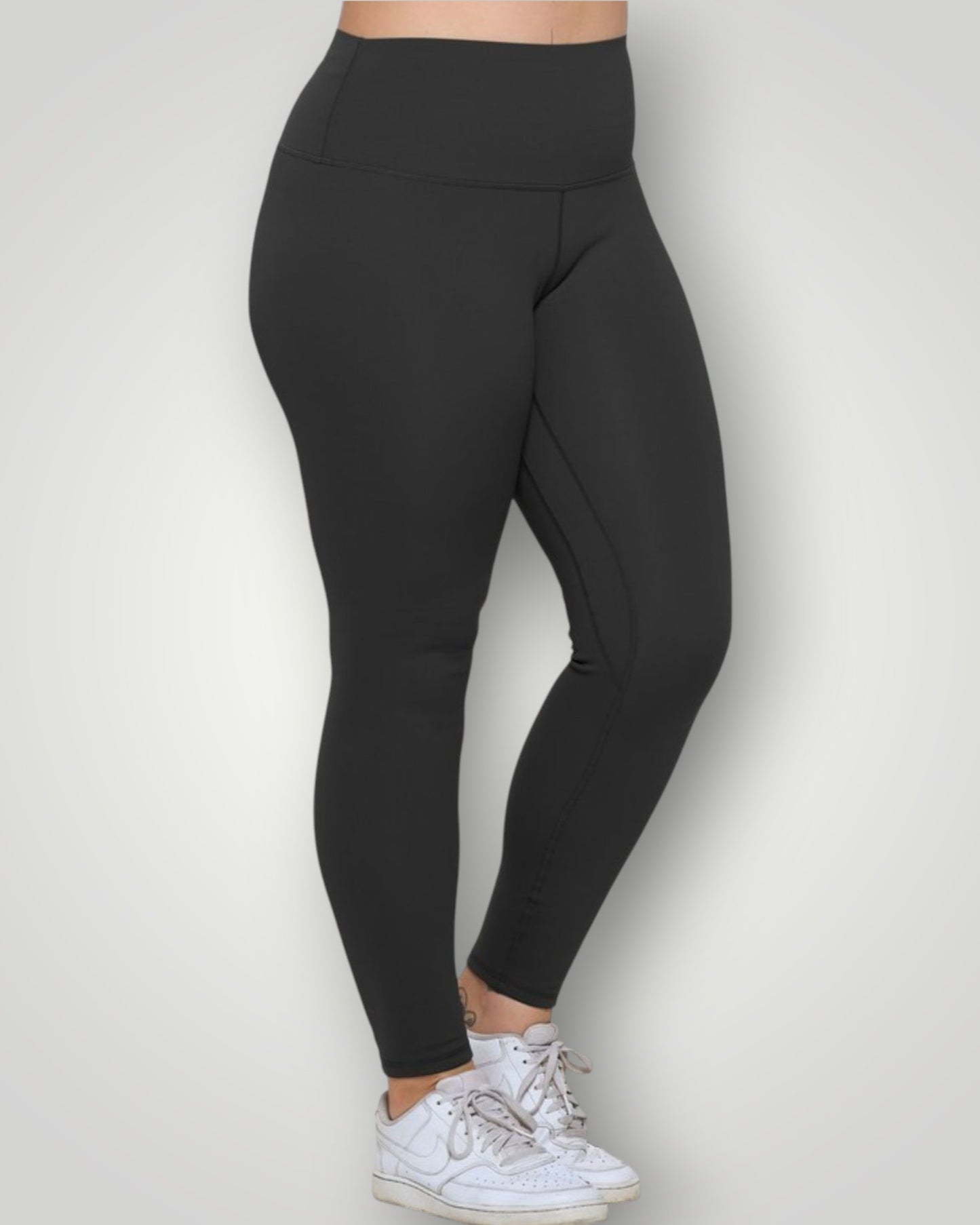 Black leggings worn by a person on a white background