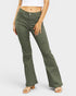 Person wearing green flared pants on a white background