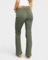 Green pants worn by a person on a white background