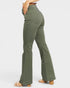 Green flared pants worn by a person on a white background
