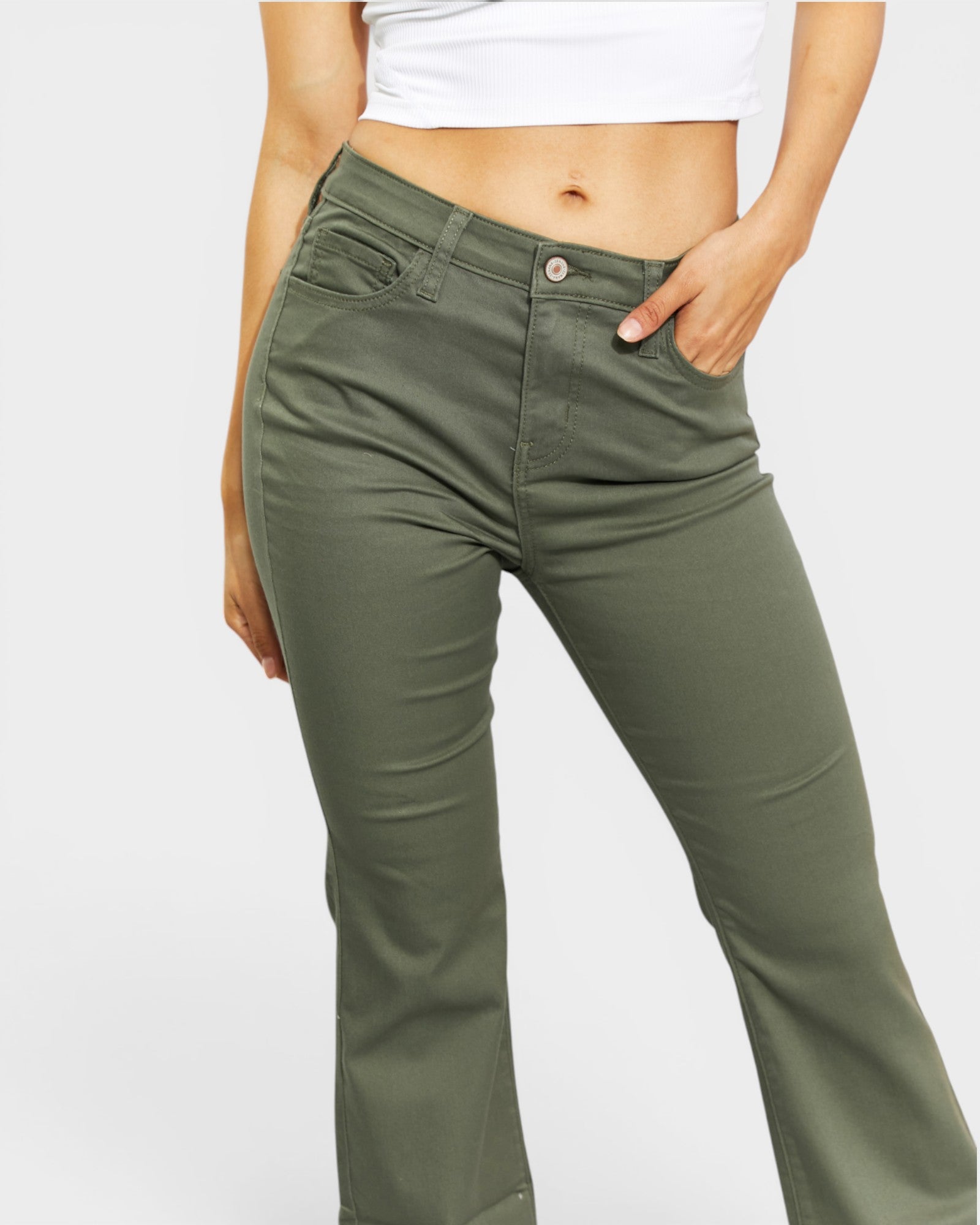 Person wearing olive green pants on a light gray background