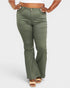 Person wearing olive green flared pants on a white background