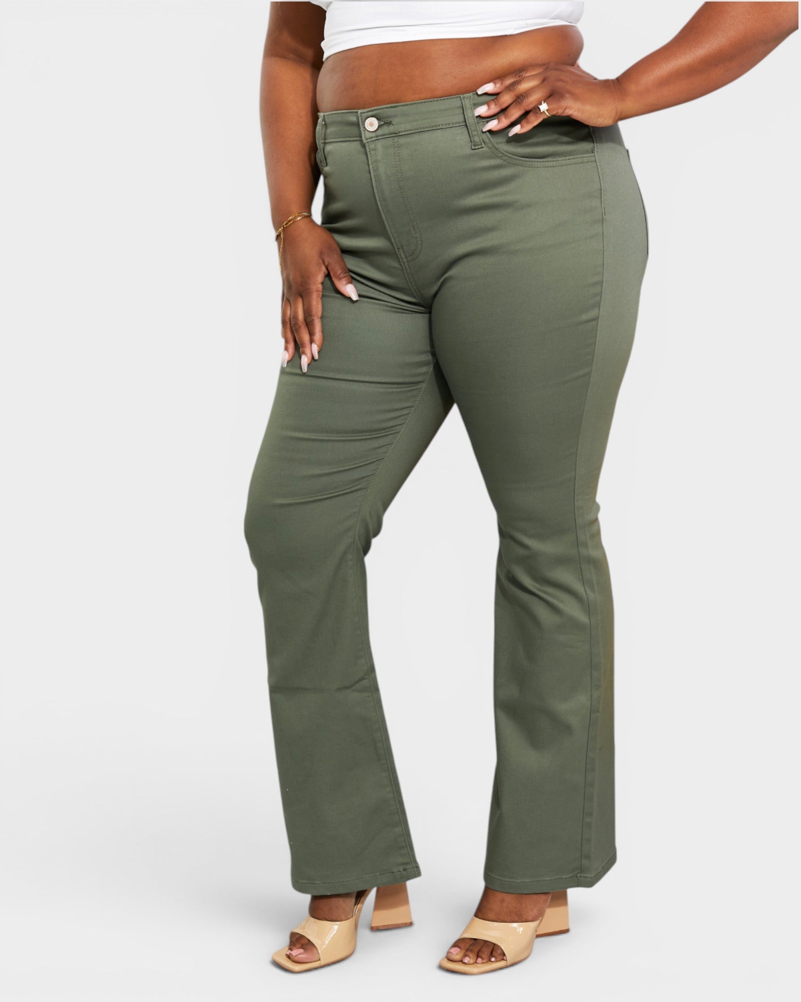 Person wearing olive green pants on a white background