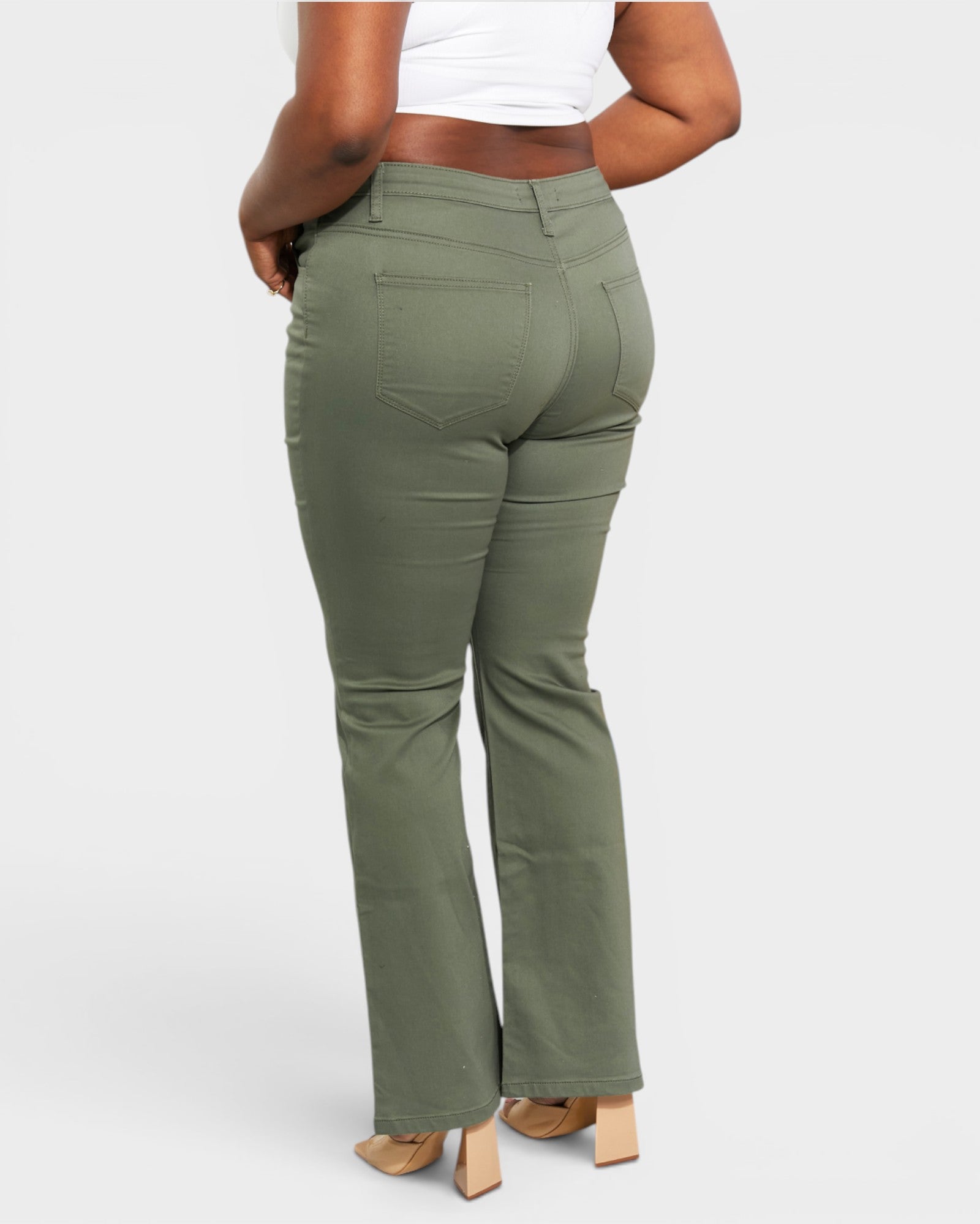 Person wearing olive green pants on a white background
