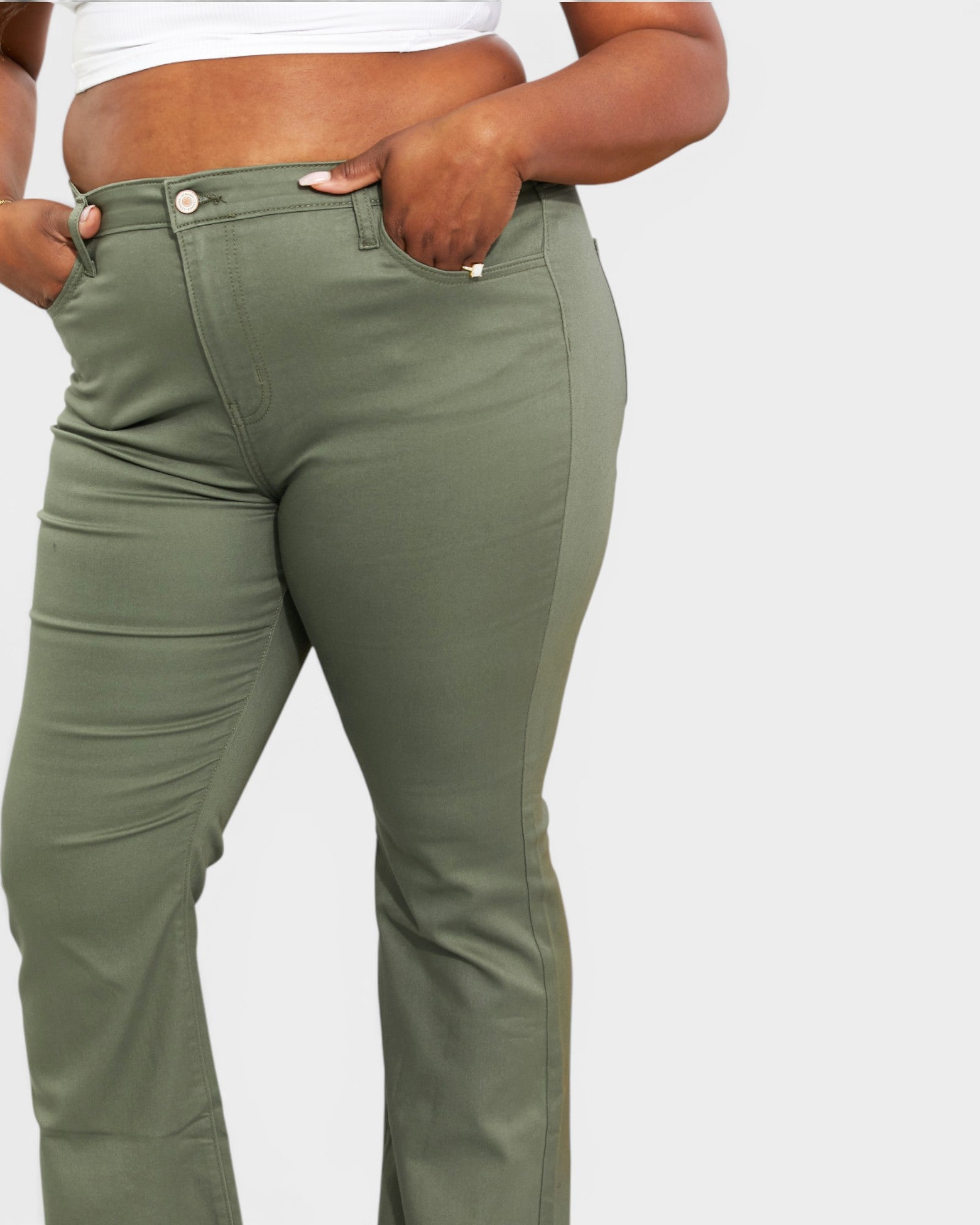 Person wearing olive green pants on a white background