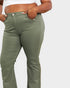 Person wearing olive green pants on a white background