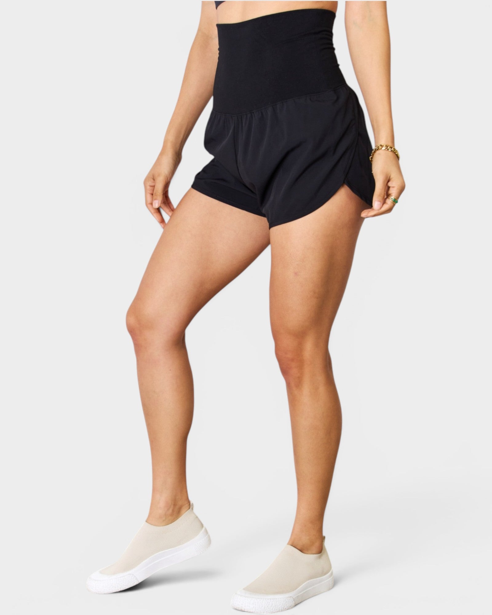 Person wearing black athletic shorts on a white background
