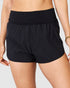 Black shorts worn by a person on a light gray background