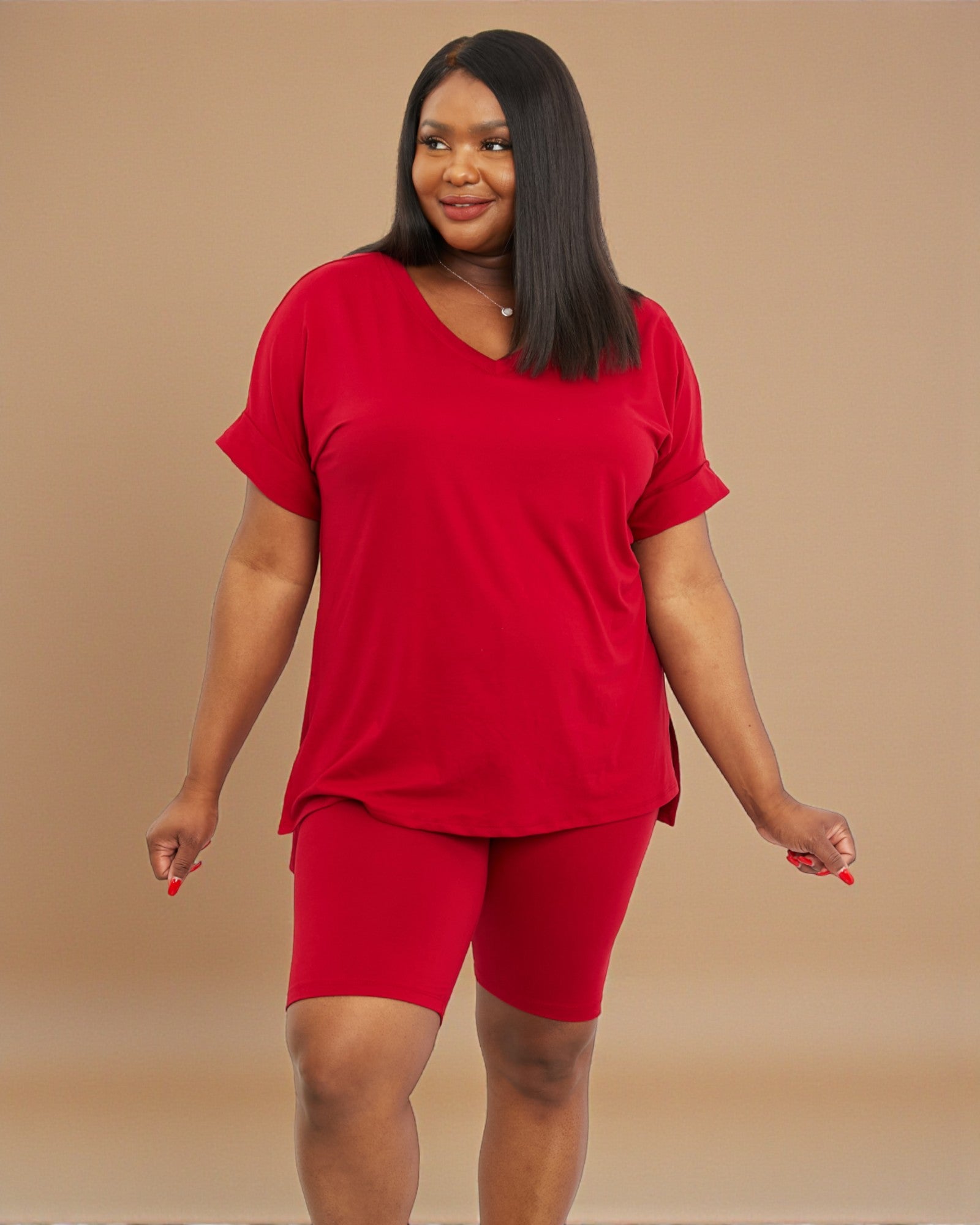 Woman wearing a red outfit on a beige background